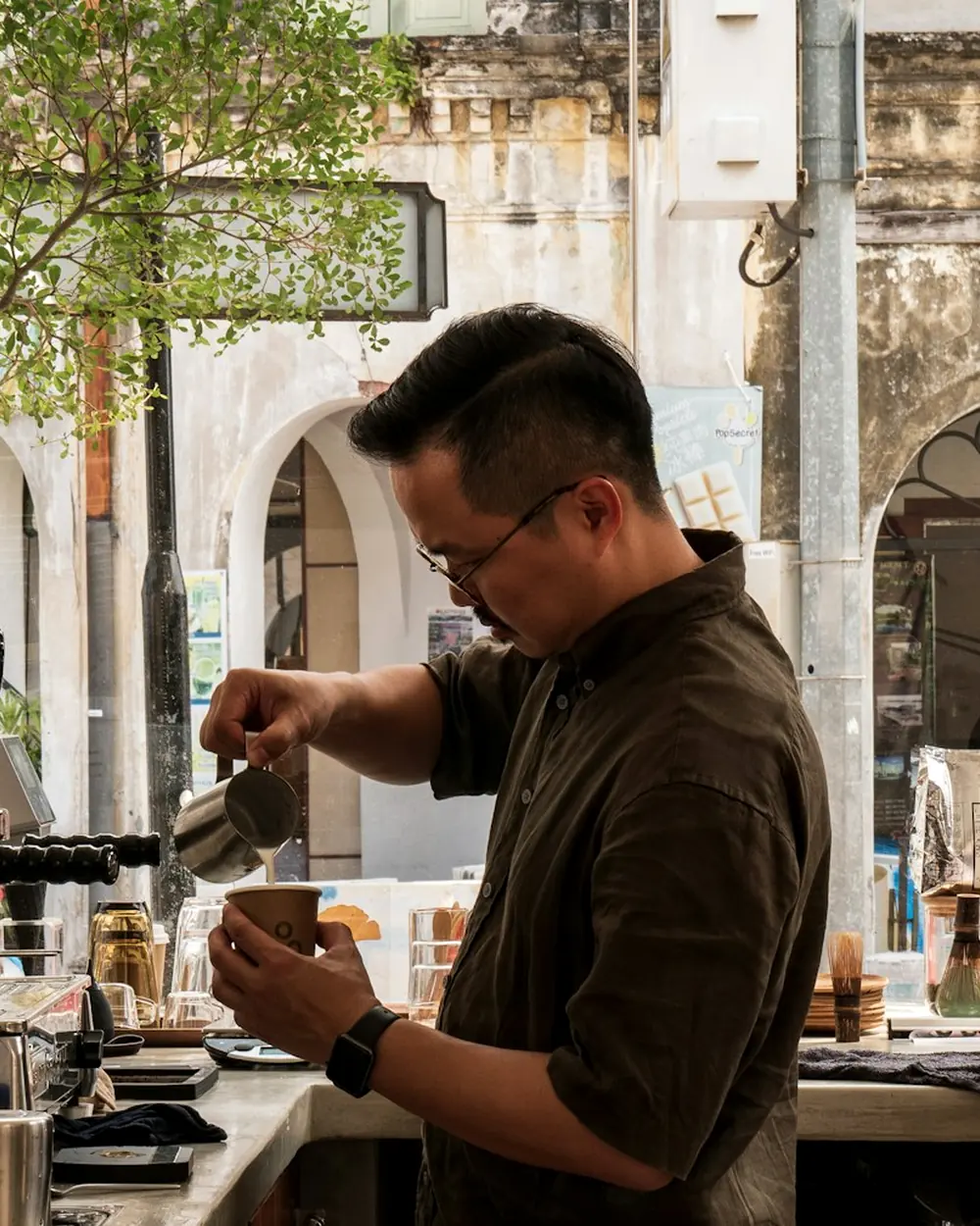 A barista preparing coffee at the counter