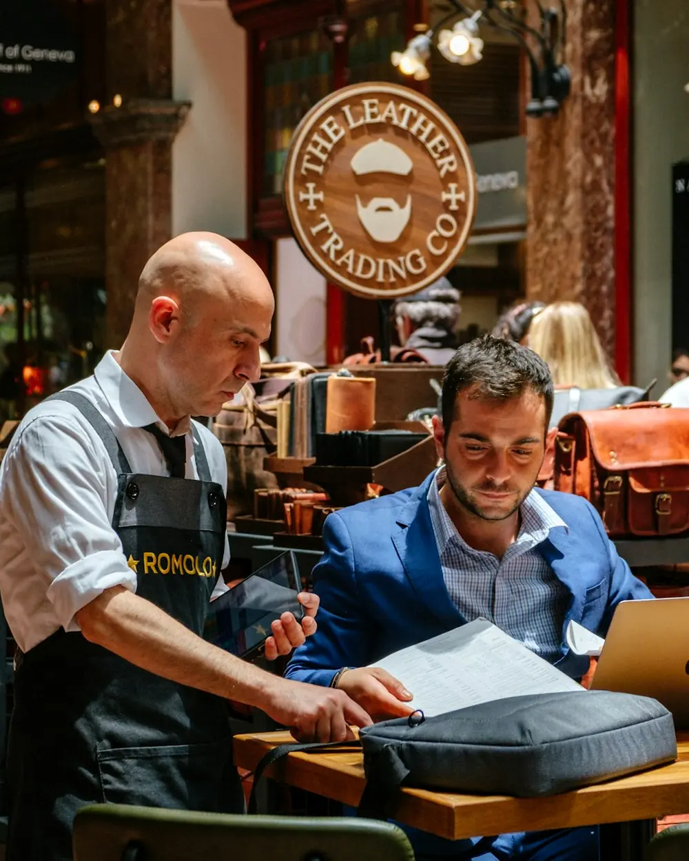 Two leatherworkers checking an order