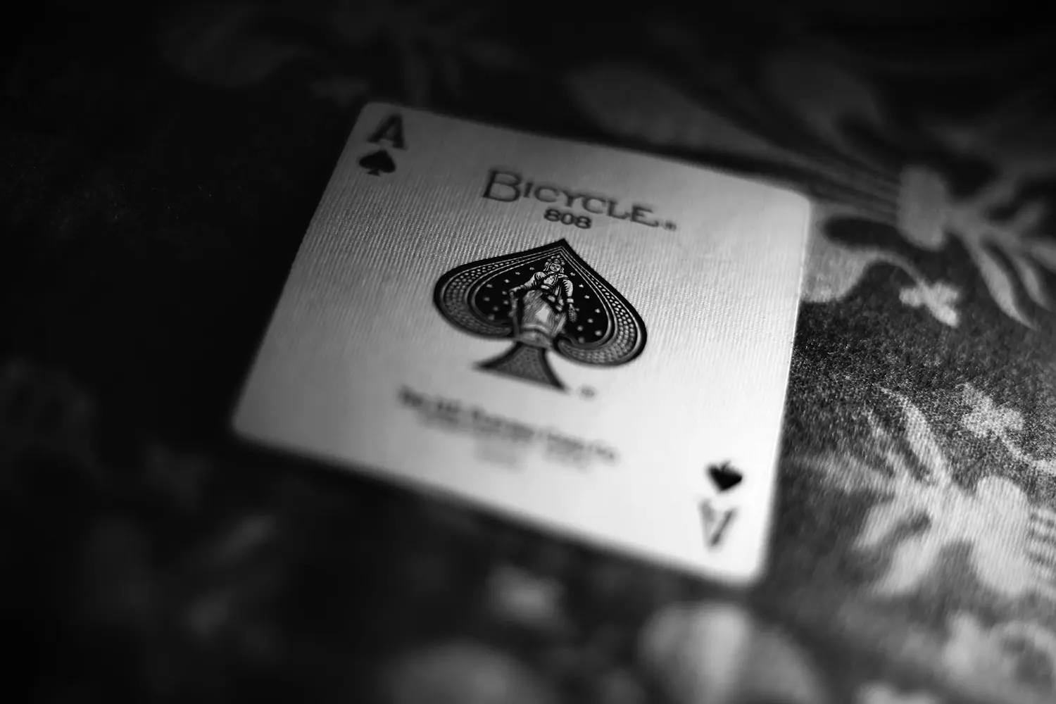 The ace of spades on a dark table