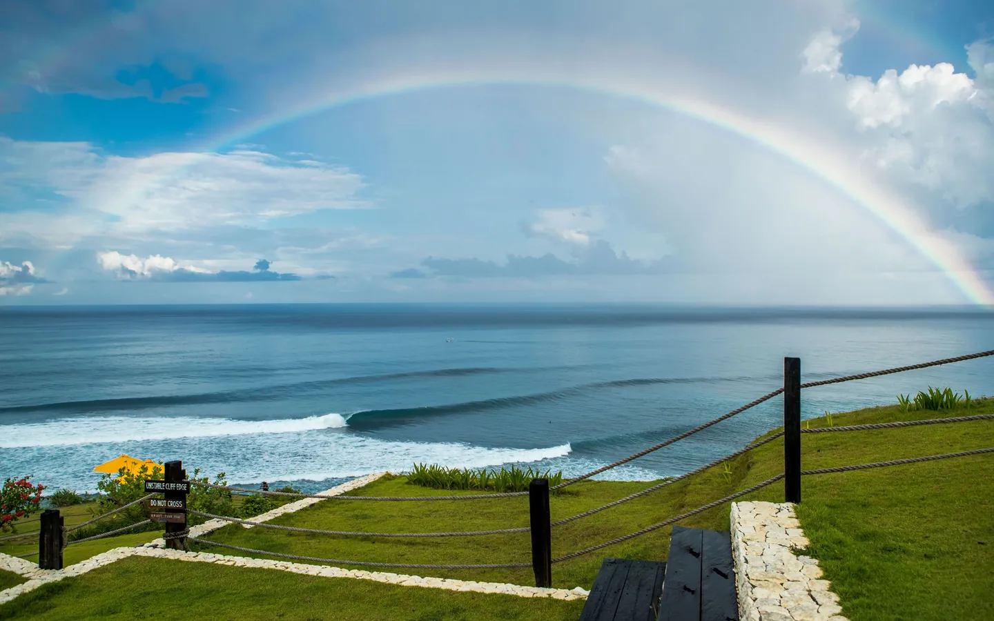 A surfer on a clean wave below the cliffs at Uluwatu