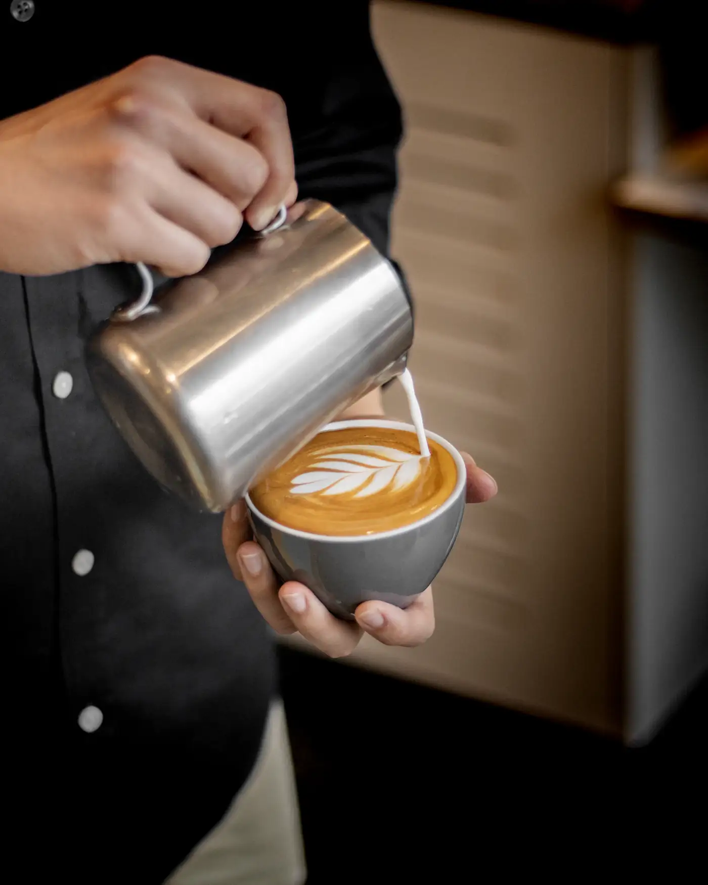 Barista pouring latte art