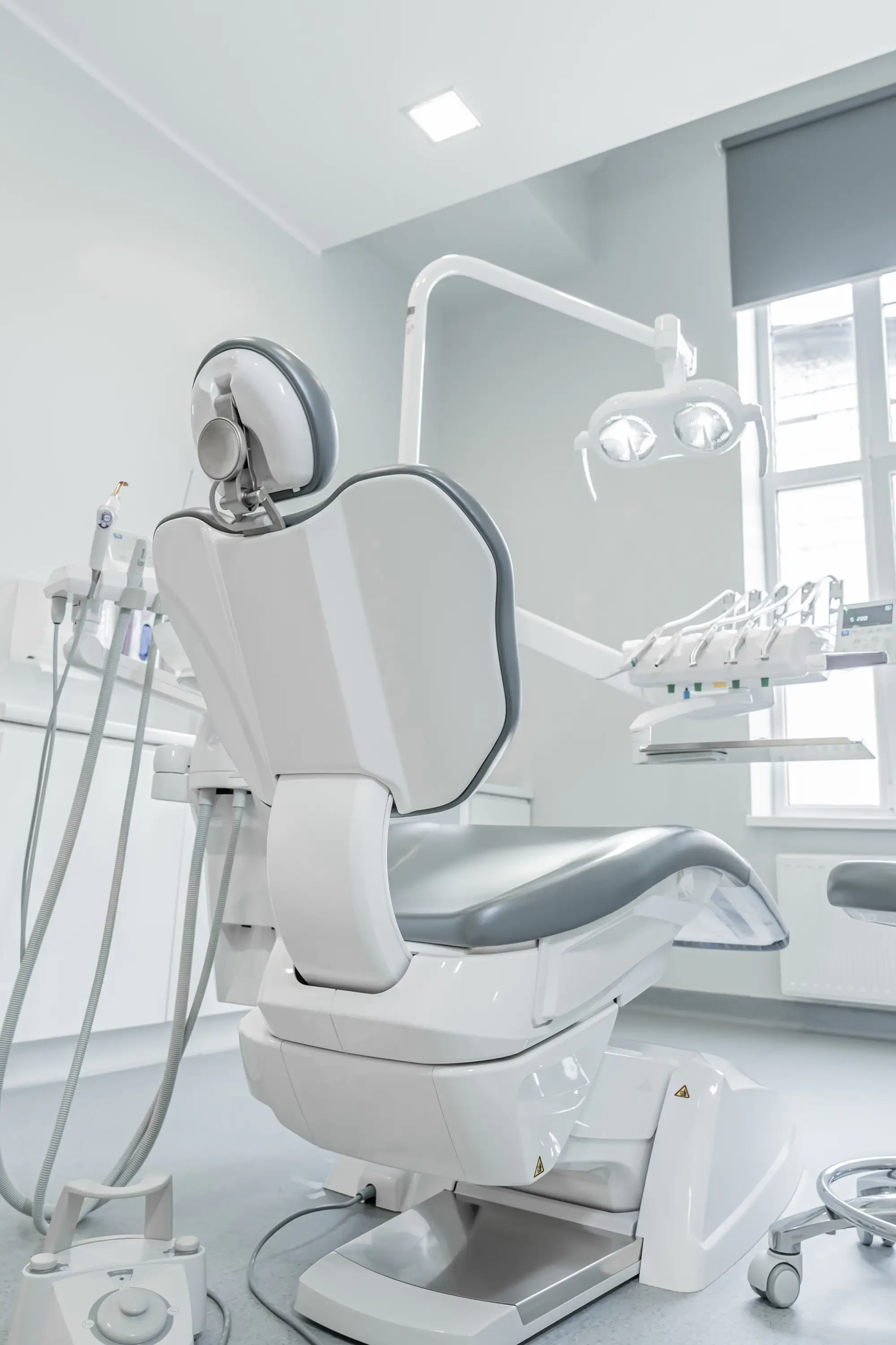 White dental chair in a bright treatment room
