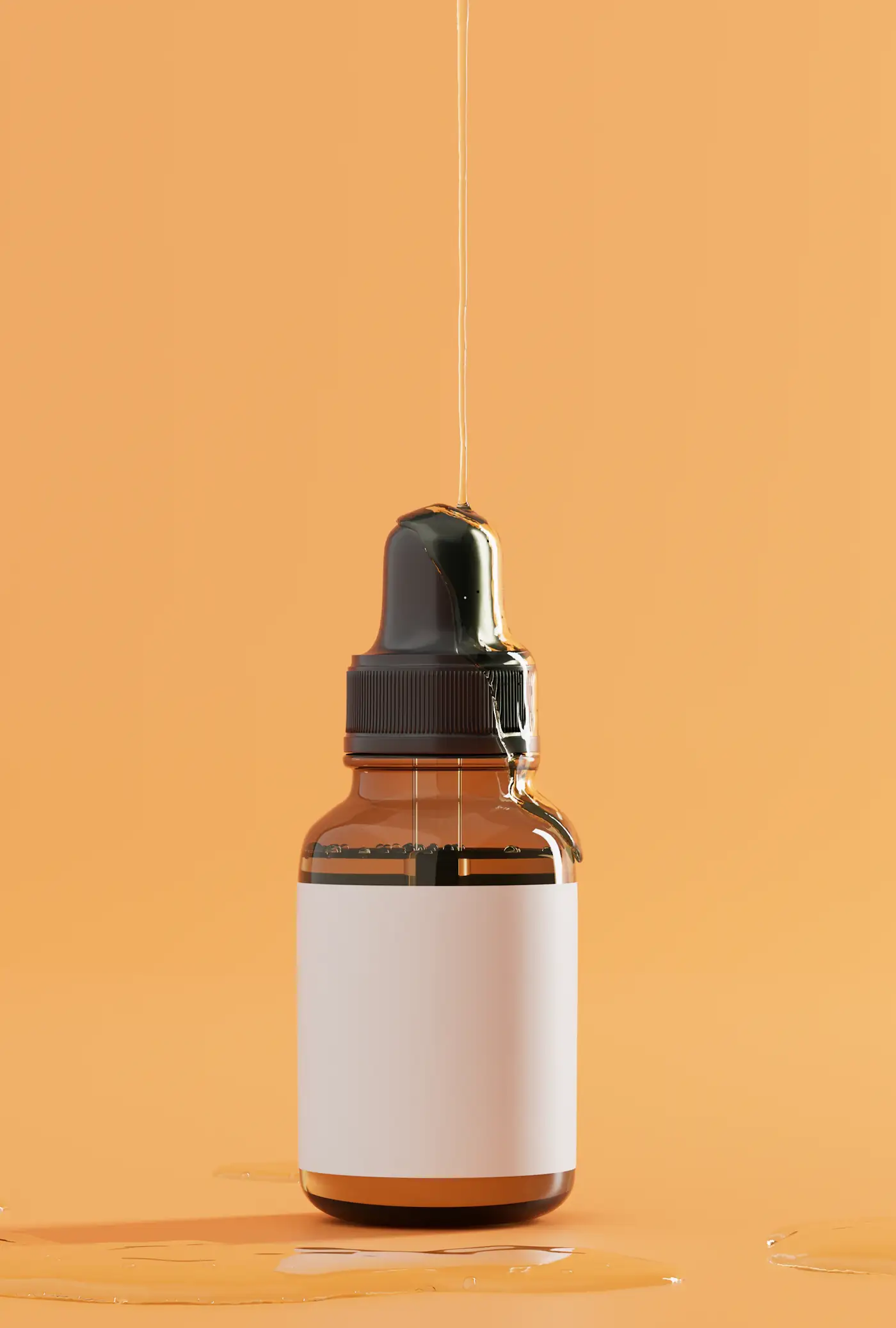 Amber dropper bottle on orange with a drip of oil