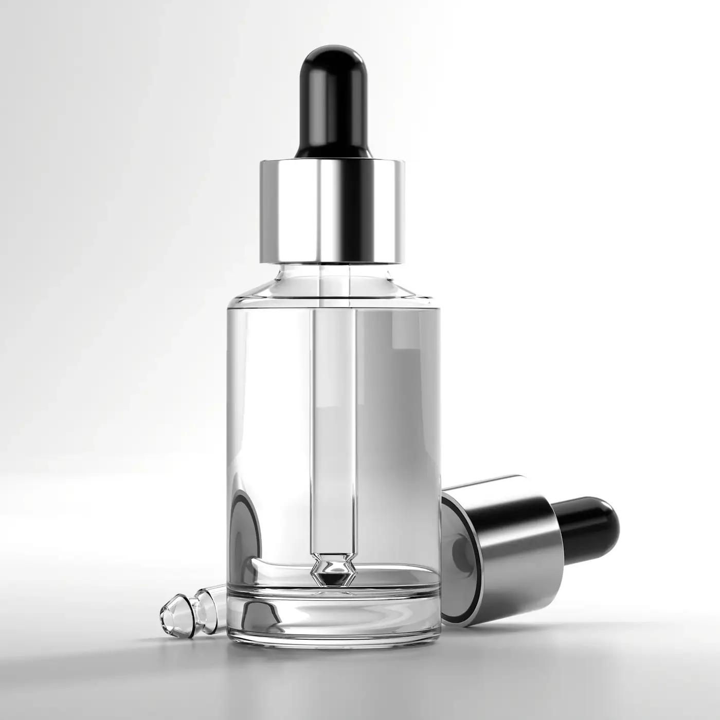 Clear glass dropper bottle on white