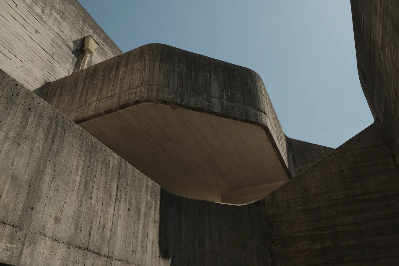 Concrete cantilever reaching out against a blue sky