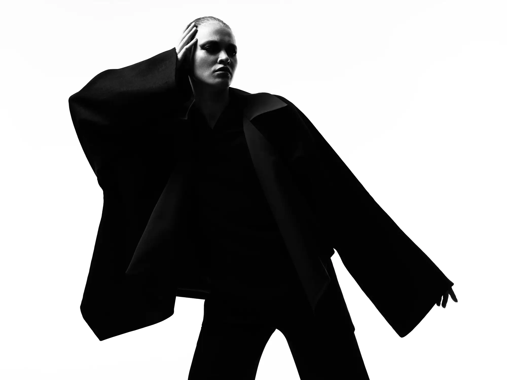 Oversized black wool coat on a model, black and white